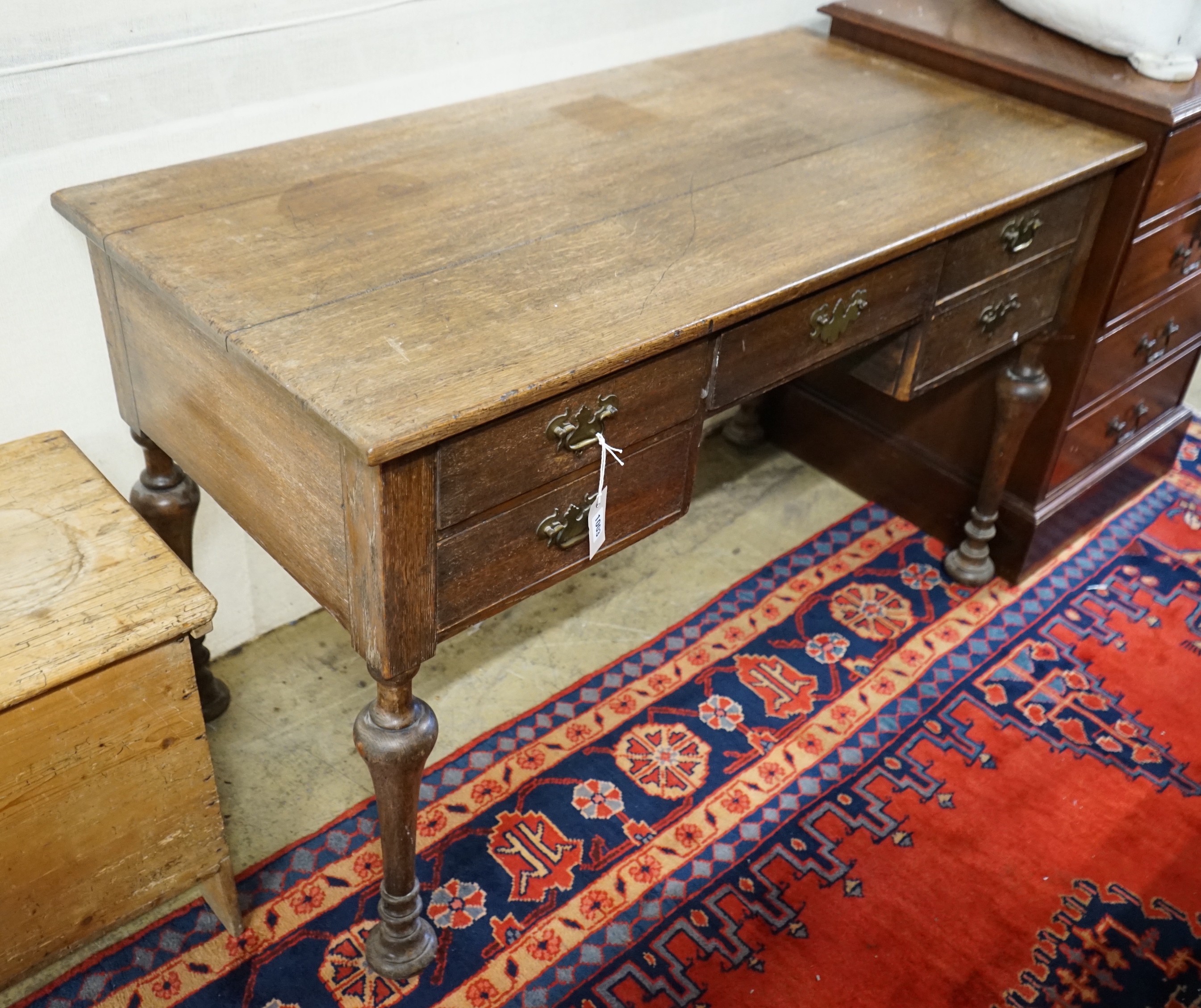 A 1920's oak kneehole desk, length 122cm, 61cm, height 76cm